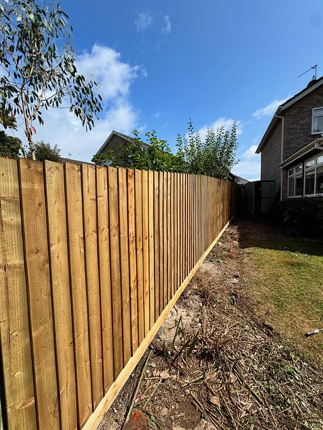 Feather-edge timber garden fence by BP Contracting, South Wales